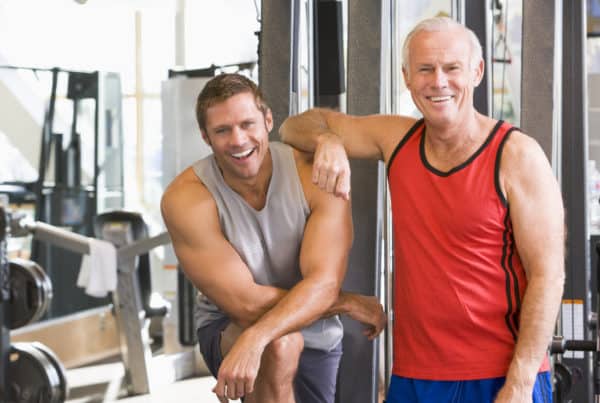Men At The Gym Together Smiling